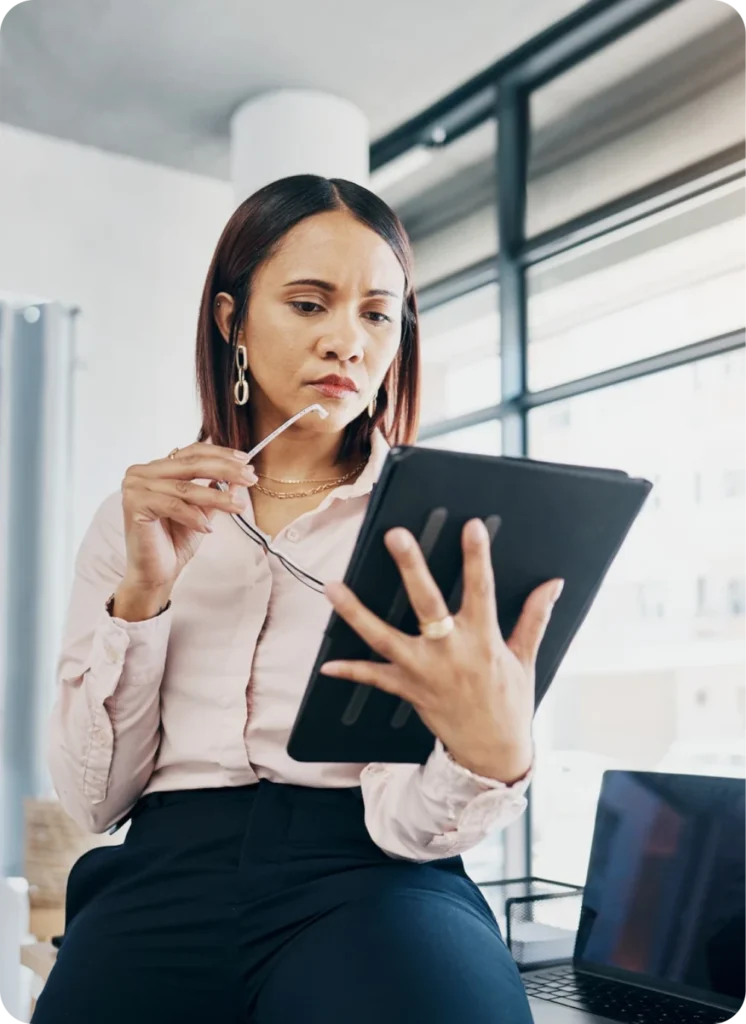 Economic consultant reviewing market research and policy data on a digital tablet